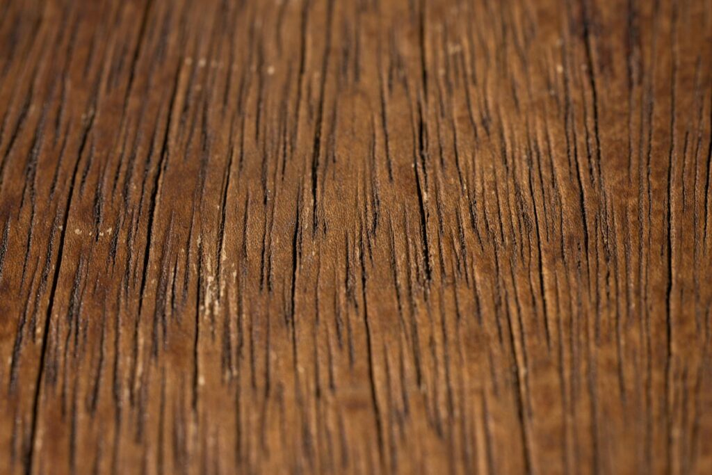 Detailed close-up of a rustic wooden surface showing natural grain and texture.